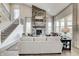 Bright living room features stone fireplace, high ceilings, large windows, and hardwood flooring at 7282 Portico Ln, McCordsville, IN 46055