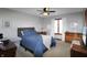 Comfortable bedroom with a full bed, ceiling fan, natural light, and hardwood floors at 7608 Andrew Turn, Plainfield, IN 46168