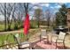 Spacious deck with outdoor seating, grill, red umbrella, and scenic view of the surrounding landscape at 7608 Andrew Turn, Plainfield, IN 46168