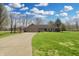Inviting ranch home featuring a well-manicured lawn, long driveway, and an attached two-car garage at 7608 Andrew Turn, Plainfield, IN 46168