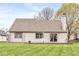 Home exterior showcasing a well-maintained yard, a wooden deck, and sliding glass doors at 7715 High View Cir, Indianapolis, IN 46236