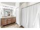 Bathroom featuring a double sink vanity, tile flooring, and shower with curtain at 7715 High View Cir, Indianapolis, IN 46236
