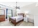 Cozy bedroom featuring a wood bed frame, ceiling fan, and natural light from clerestory windows at 7715 High View Cir, Indianapolis, IN 46236