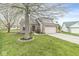 Well-maintained home with brick and siding exterior, mature trees, and a spacious front yard at 7715 High View Cir, Indianapolis, IN 46236