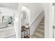 Hallway with staircase featuring a wine rack and decorative mirror at 7715 High View Cir, Indianapolis, IN 46236