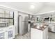 Bright kitchen featuring stainless steel appliances, a kitchen island, and modern finishes at 7715 High View Cir, Indianapolis, IN 46236