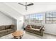 Bright living room with two sofas, a ceiling fan and a window view of the neighborhood at 7715 High View Cir, Indianapolis, IN 46236