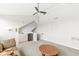 Spacious living room featuring a ceiling fan, a wet bar with sink and mini fridge, and carpeted floors at 7715 High View Cir, Indianapolis, IN 46236