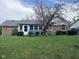 Nice backyard featuring a sunroom, brick facade, and flowering tree at 7740 5 Points Rd, Indianapolis, IN 46259