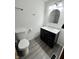 Modern bathroom features a sleek vanity with marble countertop and a stylish oval mirror at 7740 5 Points Rd, Indianapolis, IN 46259