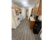 Open kitchen with modern appliances, ample counter space, and new gray vinyl flooring at 7740 5 Points Rd, Indianapolis, IN 46259