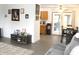 Open-concept living area with new flooring, a large television, and a dining area nearby at 7740 5 Points Rd, Indianapolis, IN 46259