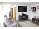 Comfortable living room featuring a gray reclining sofa, a large TV, and neutral decor at 7740 5 Points Rd, Indianapolis, IN 46259