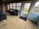 Inviting screened-in porch with wood flooring and natural light, perfect for outdoor enjoyment at 7740 5 Points Rd, Indianapolis, IN 46259