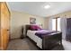 Cozy bedroom with neutral colored carpet, bed and furnishings, and large double door closet at 8095 Christopher Ct, Avon, IN 46123
