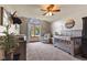 Bright Bedroom with ceiling fan, large window, neutral tones, and comfortable seating at 8095 Christopher Ct, Avon, IN 46123