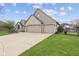 Attached two-car garage and paved driveway of home with light brick exterior at 8095 Christopher Ct, Avon, IN 46123