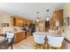 Eat-in kitchen features wood cabinets, stainless appliances, breakfast bar, and hardwood floors at 8095 Christopher Ct, Avon, IN 46123