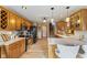 Eat-in kitchen features wood cabinets, stainless appliances, breakfast bar, and hardwood floors at 8095 Christopher Ct, Avon, IN 46123