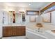 Bright main bathroom with double vanity and large soaking tub by the window at 8095 Christopher Ct, Avon, IN 46123