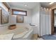 Main bathroom featuring soaking tub, bright natural light, and tiled walls at 8095 Christopher Ct, Avon, IN 46123