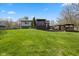 Spacious backyard with green grass, a large deck, gazebo, and mature trees at 8235 Picadilly Ln, Indianapolis, IN 46256