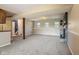 Finished basement featuring neutral carpet, natural light, and a modern fireplace at 8235 Picadilly Ln, Indianapolis, IN 46256