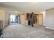 Basement area with gray carpet, mini bar, and sliding doors to the outdoor area at 8235 Picadilly Ln, Indianapolis, IN 46256
