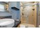 Bathroom features ceramic tile shower with glass doors, tile accents and granite countertop at 8235 Picadilly Ln, Indianapolis, IN 46256