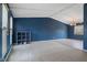 Open bonus room with blue walls, plush carpeting, and plenty of natural light at 8235 Picadilly Ln, Indianapolis, IN 46256