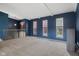 Open bonus room with blue walls, plush carpeting, and plenty of natural light at 8235 Picadilly Ln, Indianapolis, IN 46256