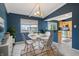 Cozy dining area featuring a modern table set, light fixture, and bright natural light at 8235 Picadilly Ln, Indianapolis, IN 46256