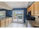 Kitchen features stainless appliances, granite countertops, light wood cabinets and a french door to the deck at 8235 Picadilly Ln, Indianapolis, IN 46256
