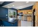 This kitchen has stainless appliances, granite countertops, light wood cabinets and a french door to the deck at 8235 Picadilly Ln, Indianapolis, IN 46256