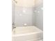 Bathroom features a tub shower, grey tile and chrome fixtures at 8506 Friendship Ln, Indianapolis, IN 46217