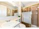Bathroom featuring a vanity, toilet, and shower with glass doors for a stylish and functional space at 8506 Friendship Ln, Indianapolis, IN 46217