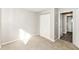 Bedroom featuring a closet, neutral walls, carpeted floors, and access to a nearby bathroom at 8506 Friendship Ln, Indianapolis, IN 46217