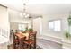 Well-lit dining room with hardwood table, adjacent to a staircase and a window seat at 8506 Friendship Ln, Indianapolis, IN 46217