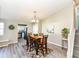 Inviting dining room with wood table, chandelier, and views into the kitchen at 8506 Friendship Ln, Indianapolis, IN 46217