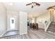 Open-concept entryway featuring wood-look floors, and a dining area with staircase to the right at 8506 Friendship Ln, Indianapolis, IN 46217