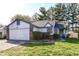 Charming single Gathering home with an attached garage, manicured lawn and blue and white trim at 8506 Friendship Ln, Indianapolis, IN 46217