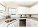 Bright kitchen featuring granite countertops, stainless steel appliances and a double sink at 8506 Friendship Ln, Indianapolis, IN 46217