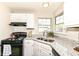 Well-lit kitchen showcasing granite counters, stainless steel appliances and double windows at 8506 Friendship Ln, Indianapolis, IN 46217