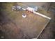 Aerial view showcasing the backyard, including a deck, play set, and storage shed at 8543 W County Road 600 S, Coatesville, IN 46121