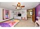 Carpeted bedroom with ceiling fan, window, and closet featuring a princess-themed bedspread at 8543 W County Road 600 S, Coatesville, IN 46121