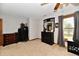 Carpeted bedroom featuring a ceiling fan, dresser with mirror, and large window at 8543 W County Road 600 S, Coatesville, IN 46121