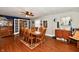 Bright dining room with wood floors, ceiling fan and a large wooden dining set at 8543 W County Road 600 S, Coatesville, IN 46121