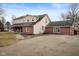 Rear exterior view showcasing architectural details and a gravel driveway at 8543 W County Road 600 S, Coatesville, IN 46121