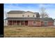 Charming two-story home featuring a welcoming front porch with rocking chairs, a perfect spot to relax at 8543 W County Road 600 S, Coatesville, IN 46121