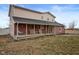 Inviting front porch with rocking chairs, a swing and a 'welcome' sign at 8543 W County Road 600 S, Coatesville, IN 46121